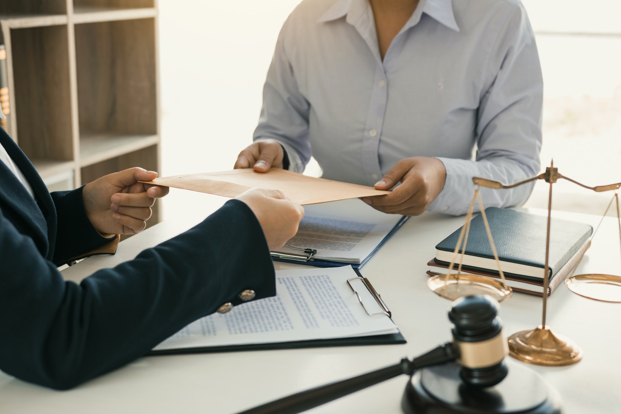 Client is submitting information on the paper of the prosecution document to the lawyer.